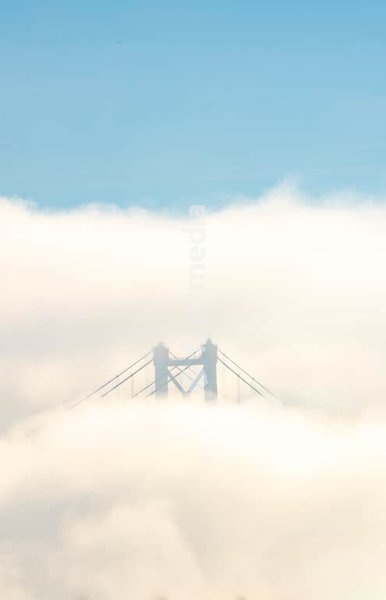 25 de Abril Bridge tower in morning fog, Tagus River Lisbon Portugal – moody minimalist detail