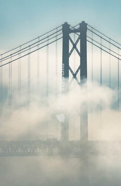 25 de Abril Bridge tower in morning fog, Tagus River Lisbon Portugal – moody minimalist detail