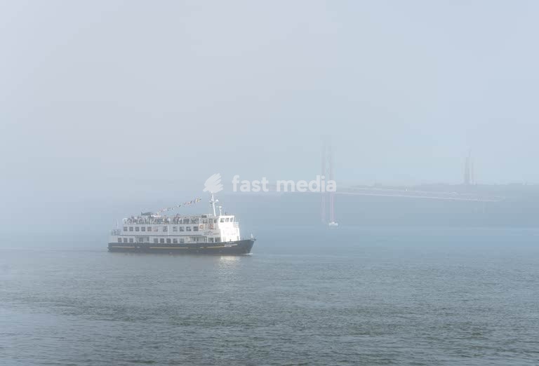 Ferry on Tagus River in morning mist, 25 de Abril Bridge Lisbon Alcantara Portugal – calm minimalist mood