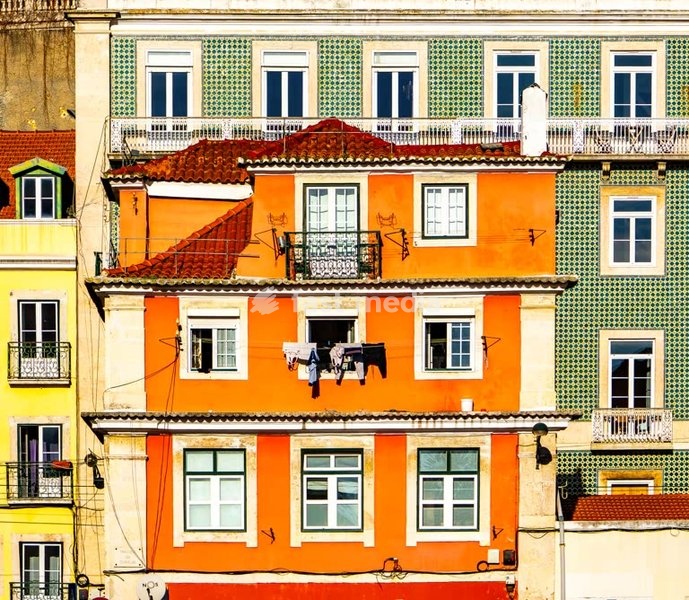 Colorful apartment facade with laundry drying and azulejo tiles, Lisbon, Portugal
