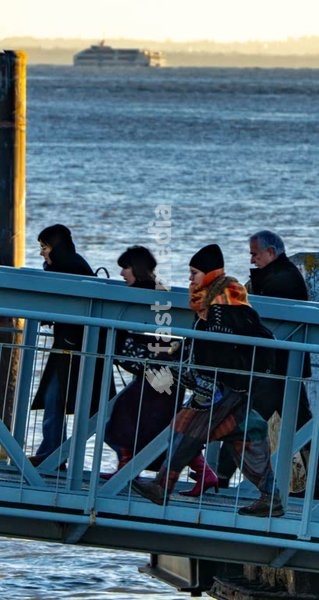 Commuters cross ferry pontoon at sunrise, Belém riverside, Tagus river, Lisbon