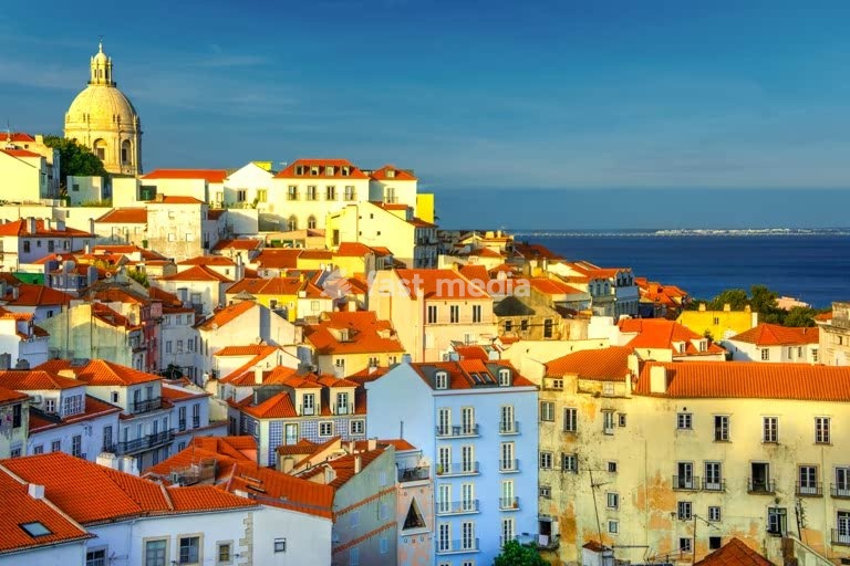 Panoramic view of Alfama's terracotta rooftops and dome, seen from Portas do Sol, Lisbon