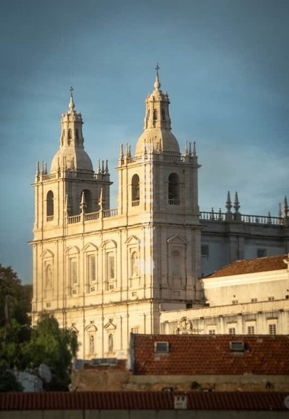 Twin baroque towers of Igreja de São Vicente de Fora against blue sky, Lisbon, Portugal