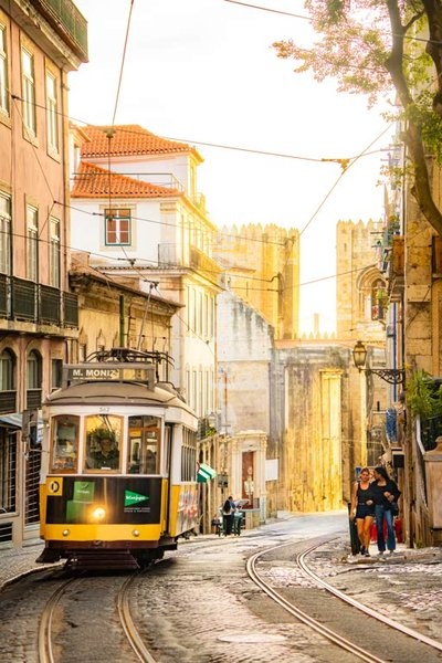 Lisbon tram 28 at Sé Cathedral, golden light on historic street, Alfama, Santa Maria Maior, Lisbon, Portugal