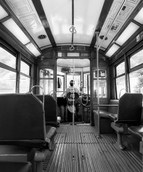 Lisbon tram interior, vintage wooden seats and driver cabin, Lisbon, Portugal, black and white travel photo
