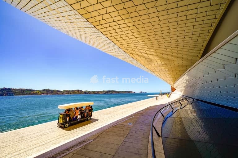 MAAT museum riverside promenade, Belém, Lisbon, beer bike tourist vehicle along the Tagus