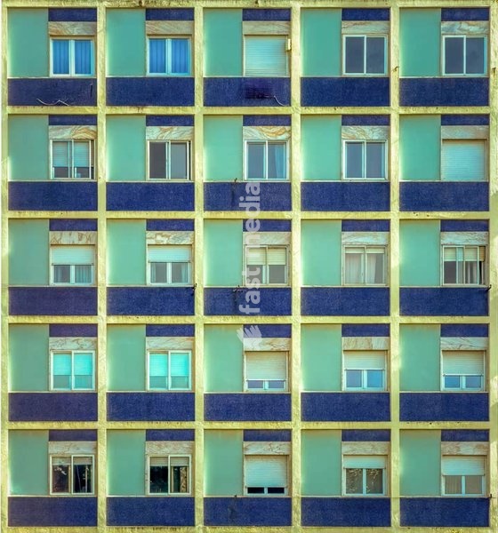 Blue tiled residential facade, grid windows, repetition, social housing, outskirts of Lisbon, Portugal
