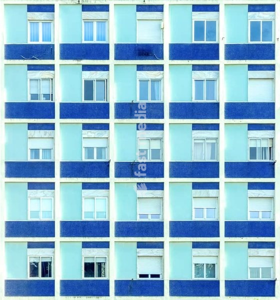 Blue tiled residential facade, grid windows, repetition, social housing, outskirts of Lisbon, Portugal