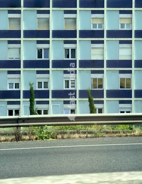 Blue tiled residential facade, grid windows, repetition, social housing, outskirts of Lisbon, Portugal