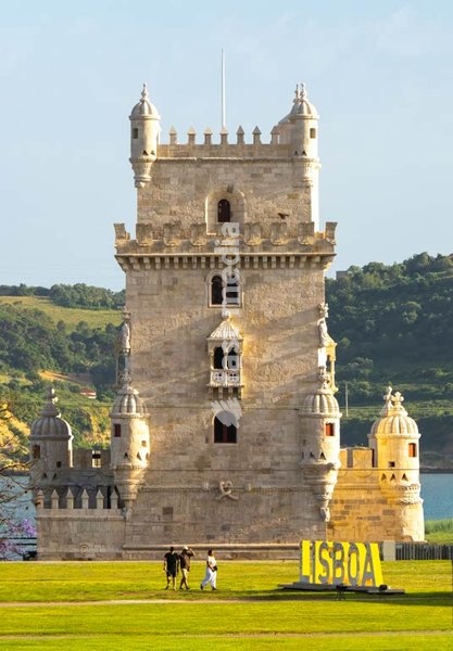 Torre de Belém fortified tower after 2026 restoration, visitors on lawn, Lisbon, Portugal
