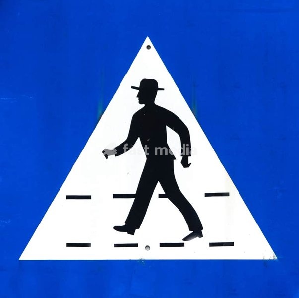 Pedestrian crossing sign, black silhouette of hatted man on blue background, Portugal, close-up