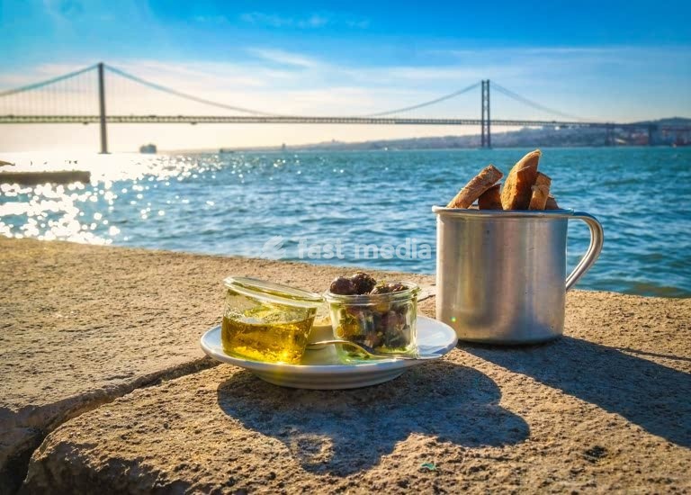 Rustic riverside snack of olives and bread sticks by the Tagus, 25 de Abril Bridge, Lisbon