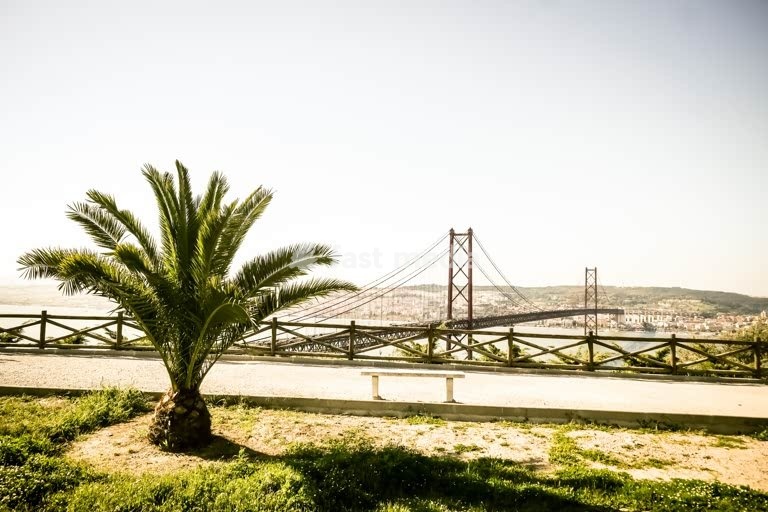 25 de Abril Bridge spans the Tagus River, Lisbon, Portugal, suspension bridge over turquoise water