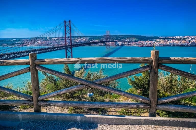 25 de Abril Bridge spans the Tagus River, Lisbon, Portugal, suspension bridge over turquoise water