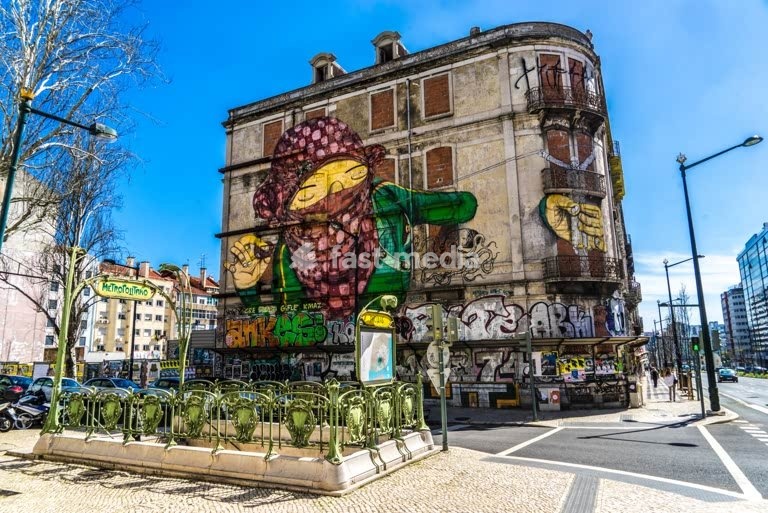 MURAL by artists Os Gêmeos, spray paint on building facade, street art, Lisbon, Portugal