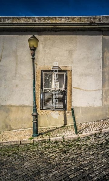 Old street lamp and shuttered window on a corner building, Lapa, Lisbon, Portugal