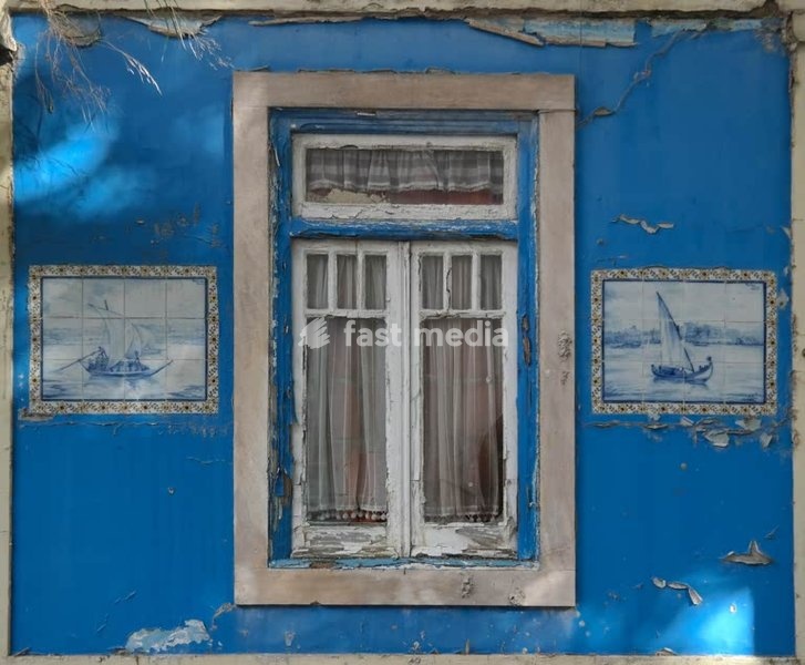 Lisbon. Old window with beautiful tile pictures