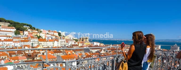 Two women enjoying the stunning view from the Elevador de Santa Justa, Lisbon