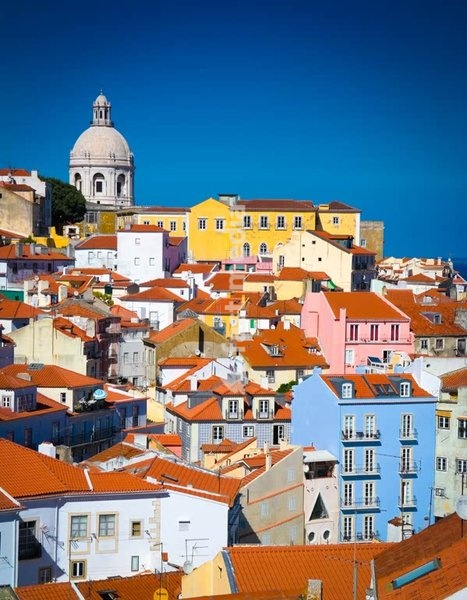 Alfama's colorful houses and terracotta rooftops beneath the National Pantheon dome, Lisbon, Portugal
