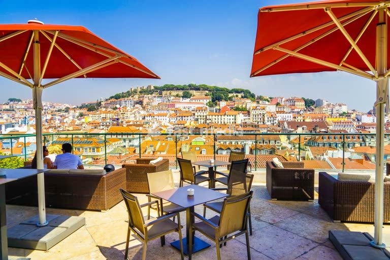 Rooftop terrace overlooks Lisbon skyline and São Jorge Castle, Chiado, Portugal