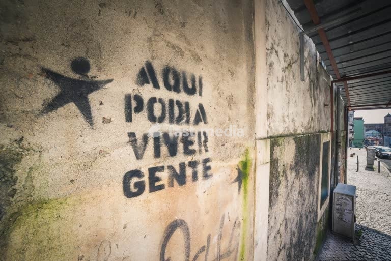 Lisbon. Artist graffity against gentrification saying People could live here