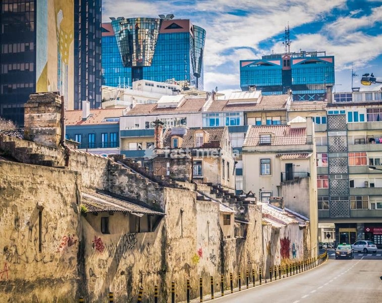 Lisbon street with the contrast of simple traditional houses and the towers of the Amoreiras Shopping Center
