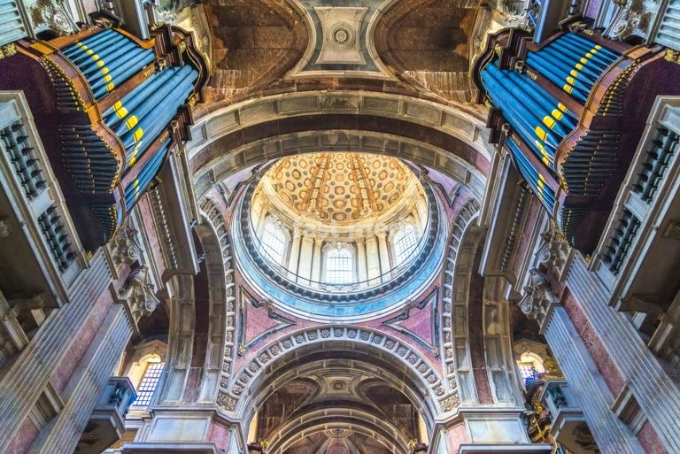 Mafra National Palace, Portugal. Grand baroque and neoclassical royal complex with basilica and twin towers. Interior view with dome and organ