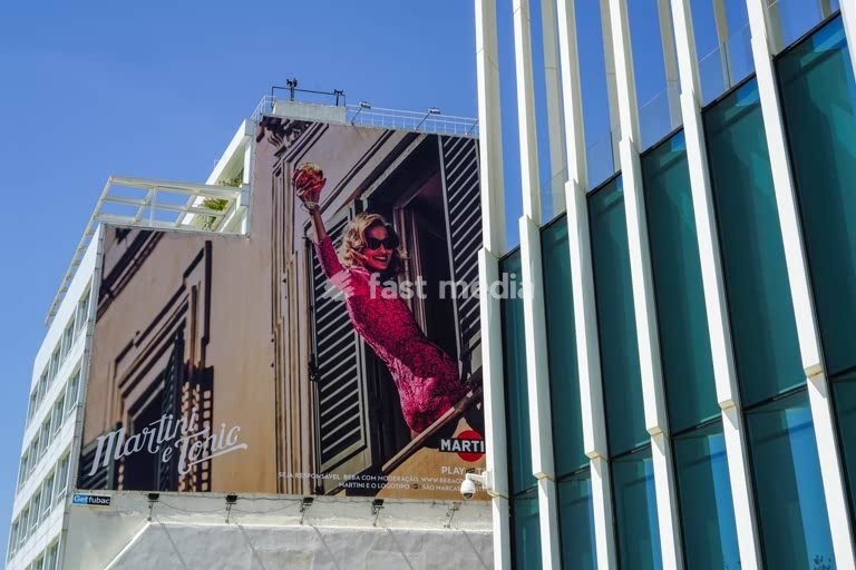 Lisbon, Portugal. Advertisement poster next to modern architecture of EDP building on avenida 24 de Julho