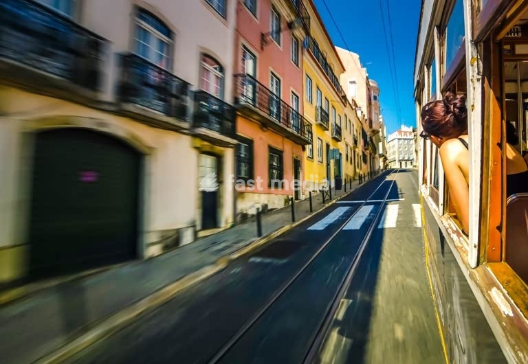 Portugal, Lisbon, woman looking out of the window of a tram