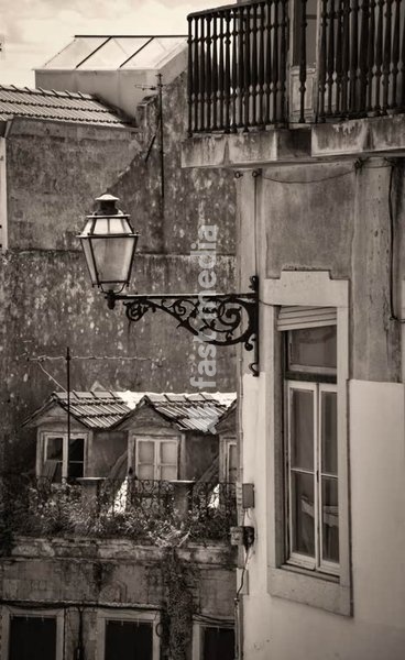Street lamps and dormers in a street in the old part of Lisbon, Portugal.