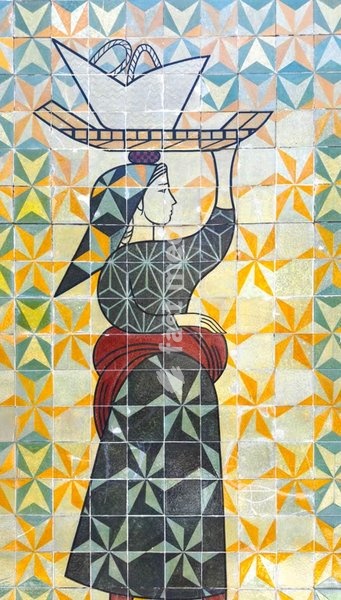 Woman in traditional clothing with a basket on her head on a ceramic mural in Lisbon, Portugal. Avenida Infante Santo