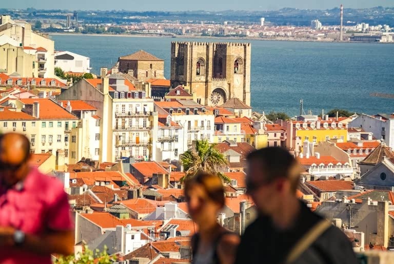 Authentic panoramic view on Lisbon's historic Sé Cathedral and terracotta rooftops overlooking the Tagus River, Portugal