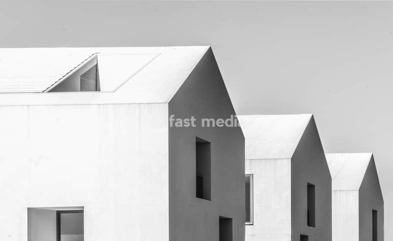 Contemporary minimalist houses on Rua Praia do Bom Sucesso, Lisbon, featuring geometric white facades and angular modernist architecture