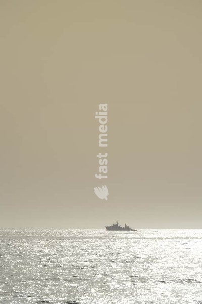 Fishing boat off the Portuguese coast in the Atlantic Ocean. Traditional vessel with fishermen at work