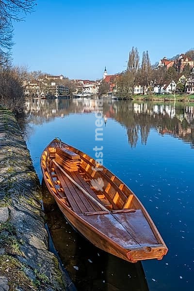 Traditional hunting boat on the Neckar River in Tübingen on a clear spring morning