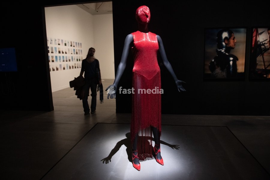 Visitors view 'Dress from Joan Collection' by Alexander McQueen at a Photocall for 'The 90s: Art And Fashion' which runs from 8th October 2026 - 14th February 2027 at TATE Britain in London, England, UK on Tuesday 6 October, 2026