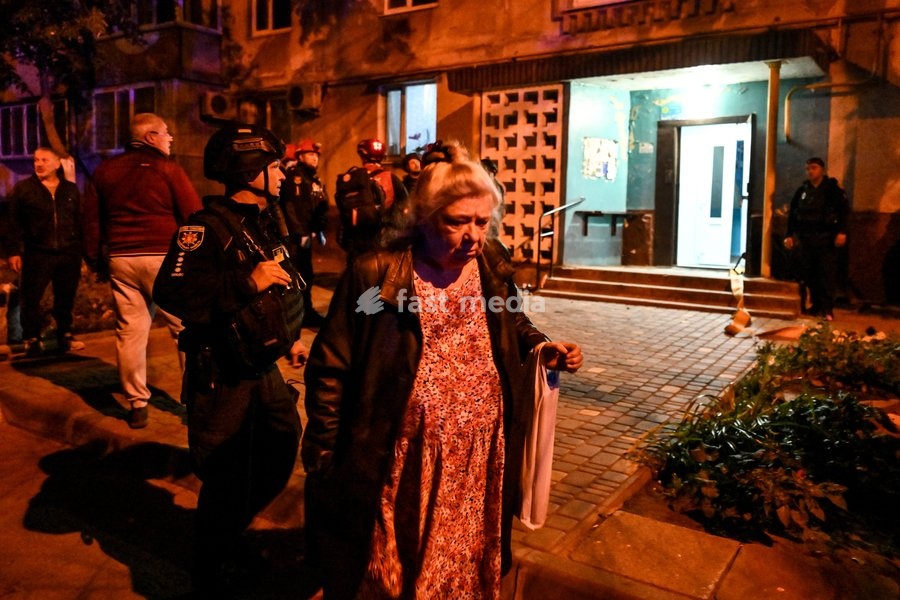 A resident of a nine-story residential building hit by a Russian drone is seen in the Kosmichnyi district of Zaporizhzhia, Ukraine, on October 5, 2026. Five people were injured in the Russian attack, one of them seriously. Rescuers evacuated three people who had been trapped on the upper floors