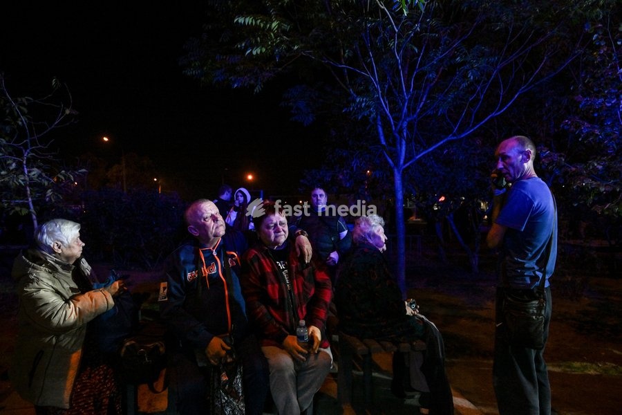 Evacuated residents of a nine-story residential building hit by a Russian drone sit on a bench during efforts to eliminate the aftermath of the Russian strike in Zaporizhzhia, Ukraine, on October 5, 2026. Five people were injured in the Russian attack, one of them seriously. Rescuers evacuated…