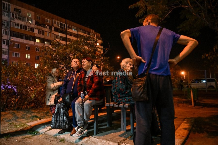Evacuated residents of a nine-story residential building hit by a Russian drone sit on a bench during efforts to eliminate the aftermath of the Russian strike in Zaporizhzhia, Ukraine, on October 5, 2026. Five people were injured in the Russian attack, one of them seriously. Rescuers evacuated…