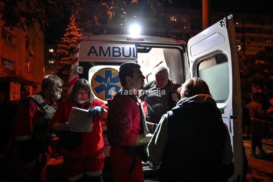 Medics stand near an ambulance during efforts to eliminate the aftermath of a Russian drone strike on a nine-story residential building in the Kosmichnyi district of Zaporizhzhia, Ukraine, on October 5, 2026. Five people were injured in the Russian attack, one of them seriously. Rescuers evacuated…