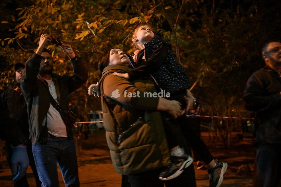A girl watches as her mother is rescued from an apartment where she was trapped in a nine-story residential building hit by a Russian drone in the Kosmichnyi district of Zaporizhzhia, Ukraine, on October 5, 2026. Five people were injured in the Russian attack, one of them seriously. Rescuers…