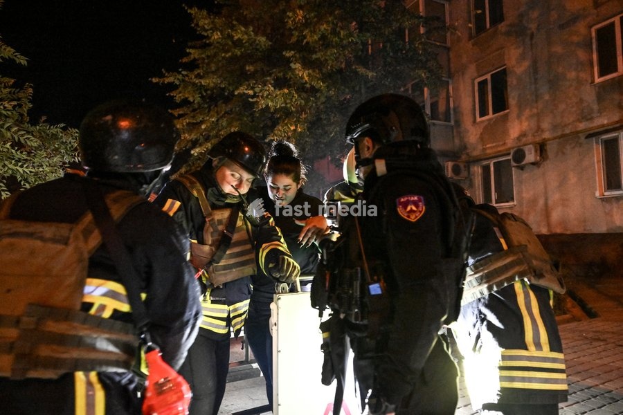 A woman evacuated from a blocked apartment in a nine-story residential building descends an aerial ladder during efforts to eliminate the aftermath of a Russian drone strike on the building in the Kosmichnyi district of Zaporizhzhia, Ukraine, on October 5, 2026. Five people were injured in the…