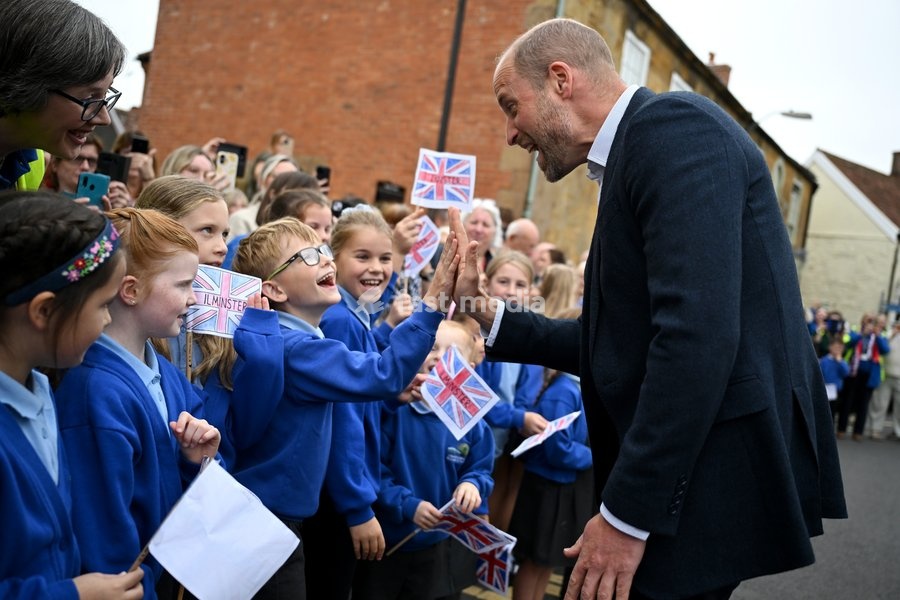 ILMINSTER, ENGLAND - OCTOBER 06: Prince William, Prince of Wales, high-fives members from the local school during his visit to Sweet Surprise cafe on October 06, 2026 in Ilminster, England. The Prince of Wales visited Ilminster in Somerset to learn about communities growing their resilience to wild…