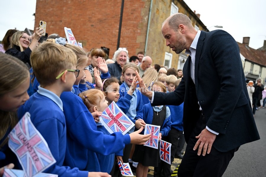 ILMINSTER, ENGLAND - OCTOBER 06: Prince William, Prince of Wales, high-fives members from the local school during his visit to Sweet Surprise cafe on October 06, 2026 in Ilminster, England. The Prince of Wales visited Ilminster in Somerset to learn about communities growing their resilience to wild…