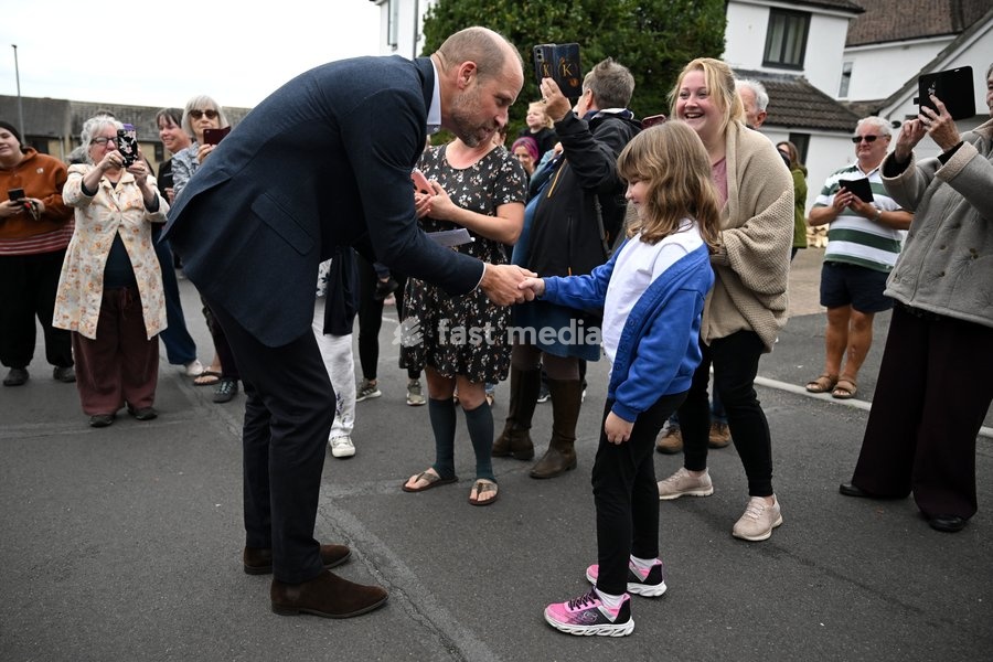ILMINSTER, ENGLAND - OCTOBER 06: Prince William, Prince of Wales receives a card for Princess Charlotte from a young well wisher during his visit to Ilminster Fire Station on October 06, 2026 in Ilminster, England. The Prince of Wales visited Ilminster in Somerset to learn about communities growing…