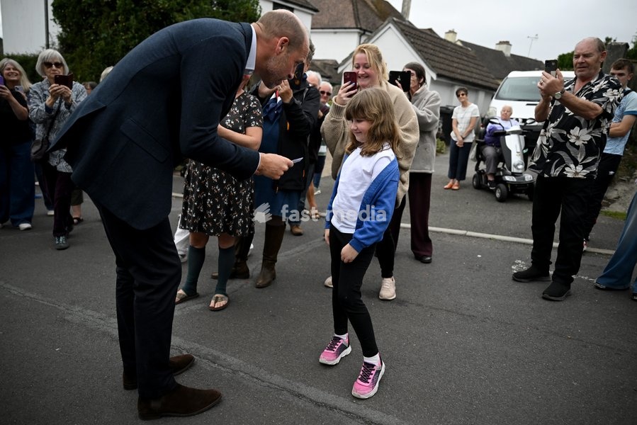 ILMINSTER, ENGLAND - OCTOBER 06: Prince William, Prince of Wales receives a card for Princess Charlotte from a young well wisher during his visit to Ilminster Fire Station on October 06, 2026 in Ilminster, England. The Prince of Wales visited Ilminster in Somerset to learn about communities growing…