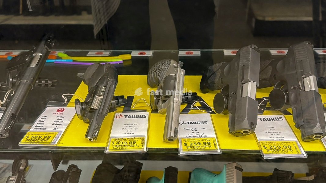 Assortment of firearms in a display case for sale with price tags at a Fleet Farm store in Minnesota