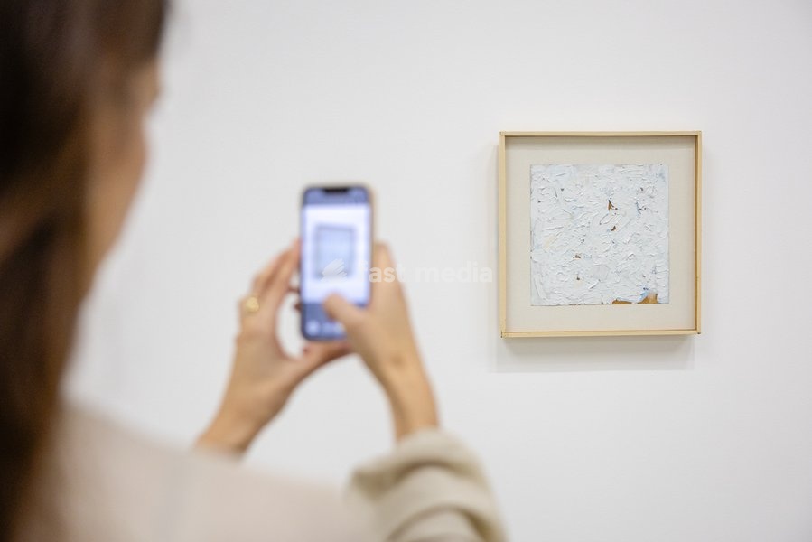 A painting of six strokes in the lower right corner, signed left center in flesh orange and top in neutral, measuring 10" x 10", 1961 on display at Robert Ryman: The Real Thing at the Barbican Art Gallery, London, UK, on 7 October 2026. The first significant UK exhibition of American minimalist and…