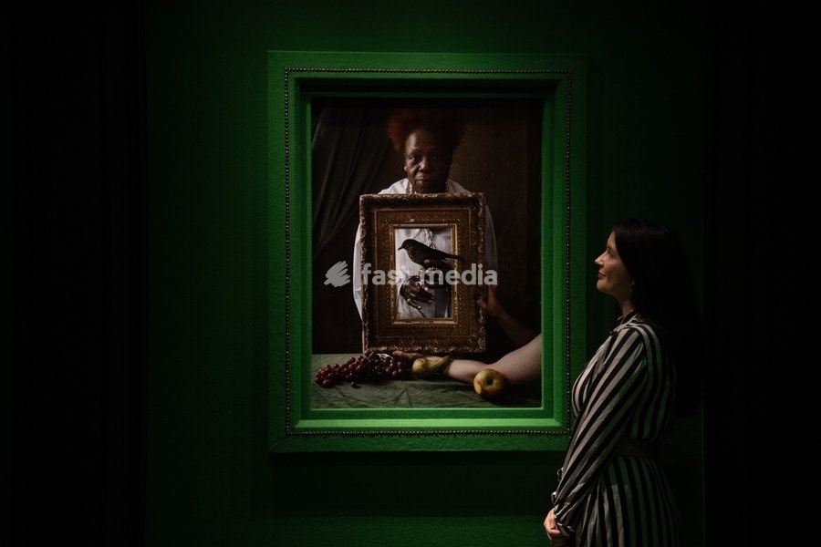 A staff member views 'Olivette Cole-Wilson, and blackbird' by Tim Walker as part of The National Portrait Gallery's 'Tim Walker's Fairyland: Love and Legends' Exhibition which runs from 9th October 2026 - 7th February 2027 at National Portrait Gallery in London, England, UK on Wednesday 7 October,…