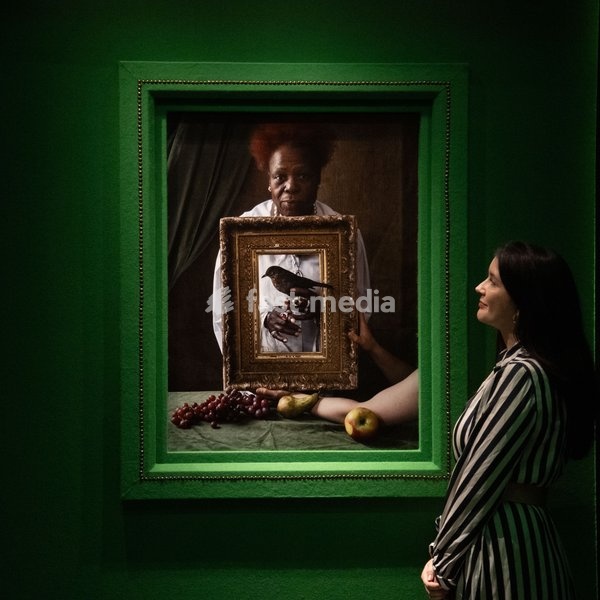 A staff member views 'Olivette Cole-Wilson, and blackbird' by Tim Walker as part of The National Portrait Gallery's 'Tim Walker's Fairyland: Love and Legends' Exhibition which runs from 9th October 2026 - 7th February 2027 at National Portrait Gallery in London, England, UK on Wednesday 7 October,…